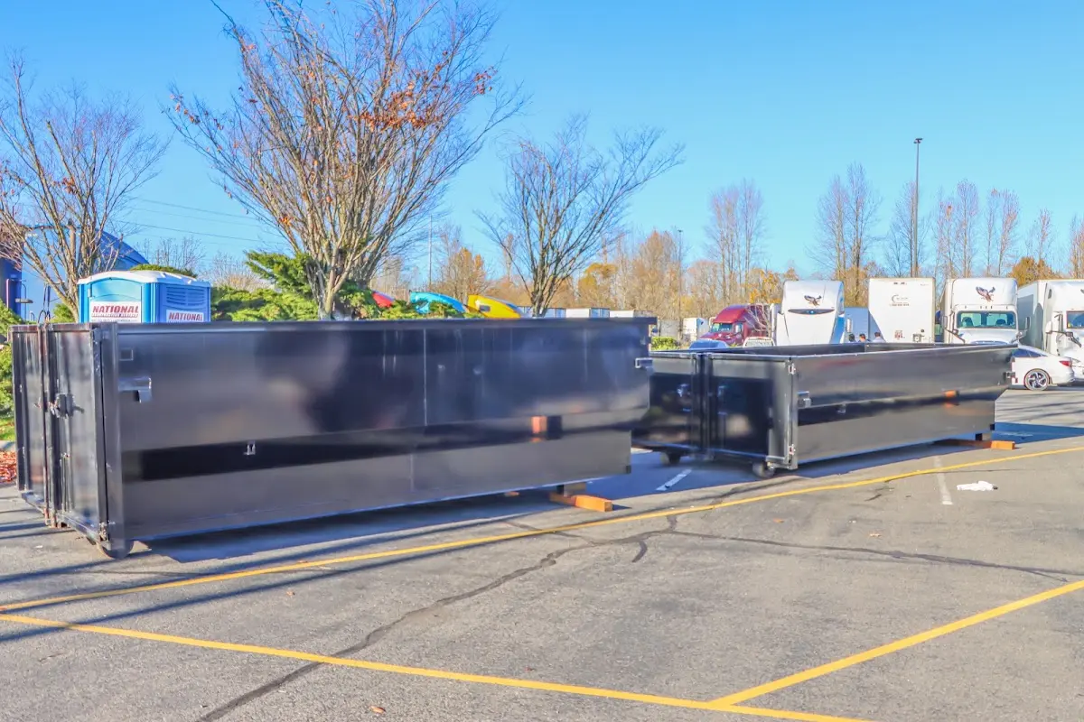 Professional dumpster rental service with roll-off container on residential driveway in Thomasville